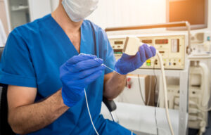 A doctor in scrubs preparing Radiofrequency Ablation.
